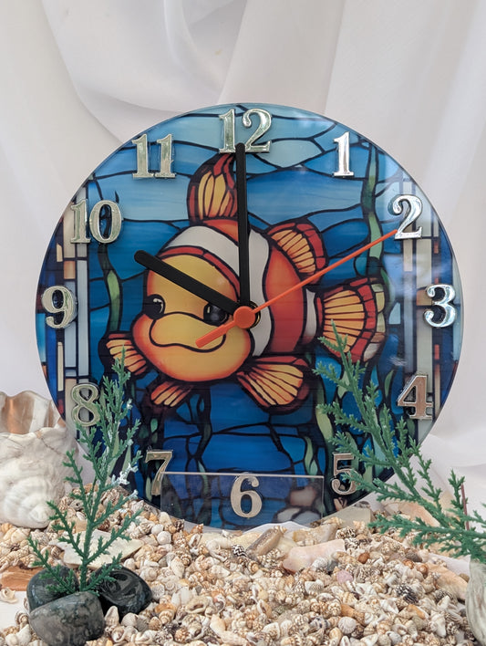 Decorative clock with a clownfish design on a white background