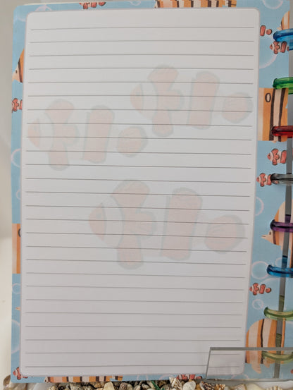 Notebook with lined pages on a colorful background