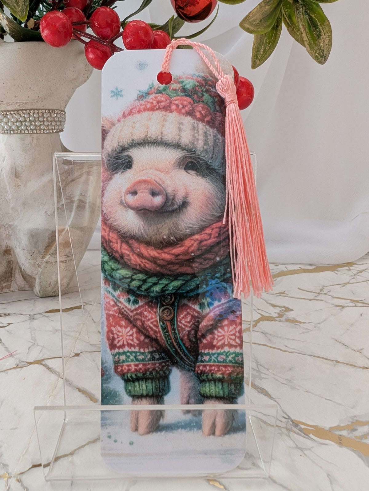 Christmas Pig laminated bookmark by Paws and Glow.  Baby pig in Sweater and woolly hat, handmade in the UK
