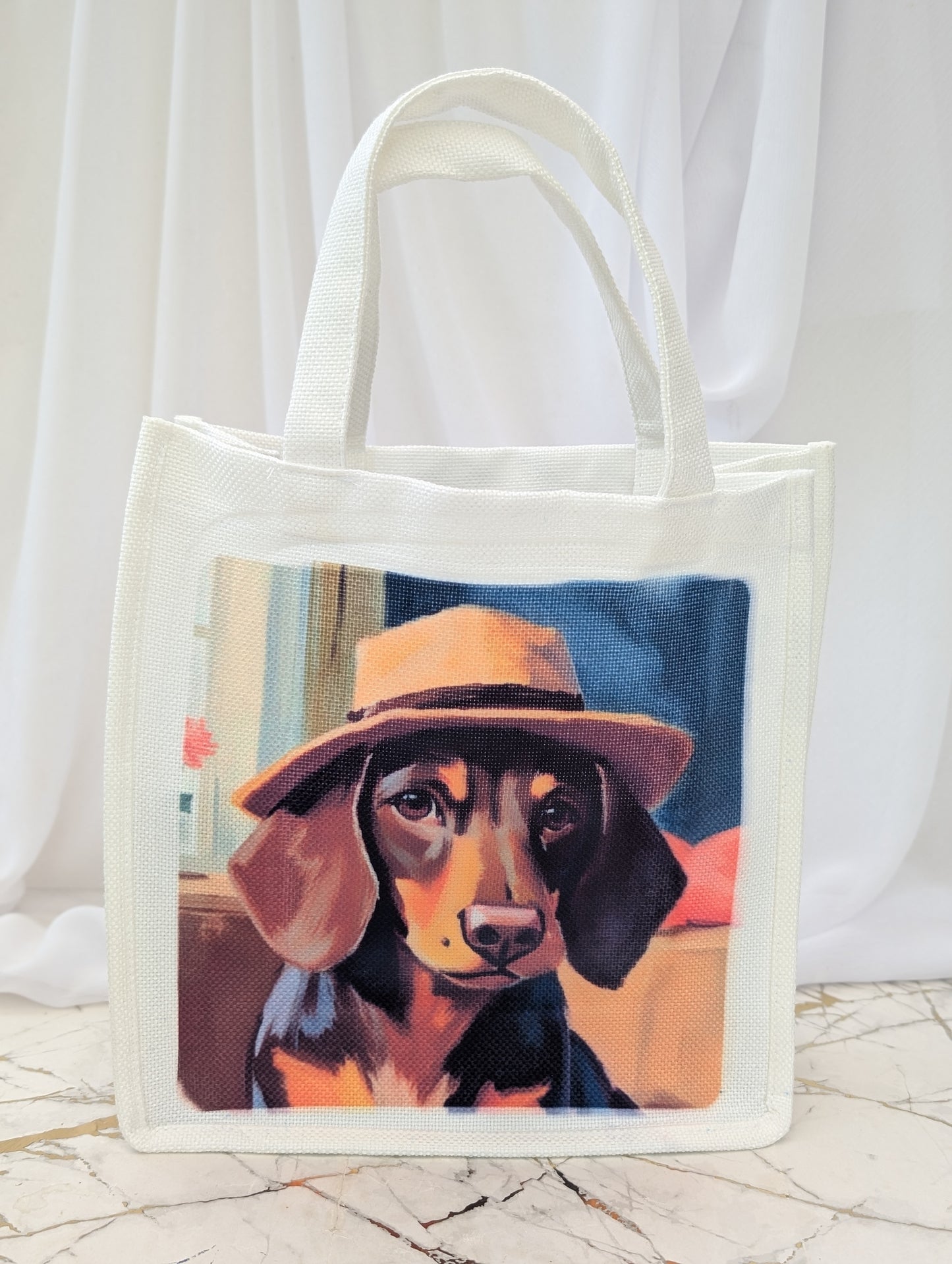Tote bag with a painting of a dog wearing a hat on a white background