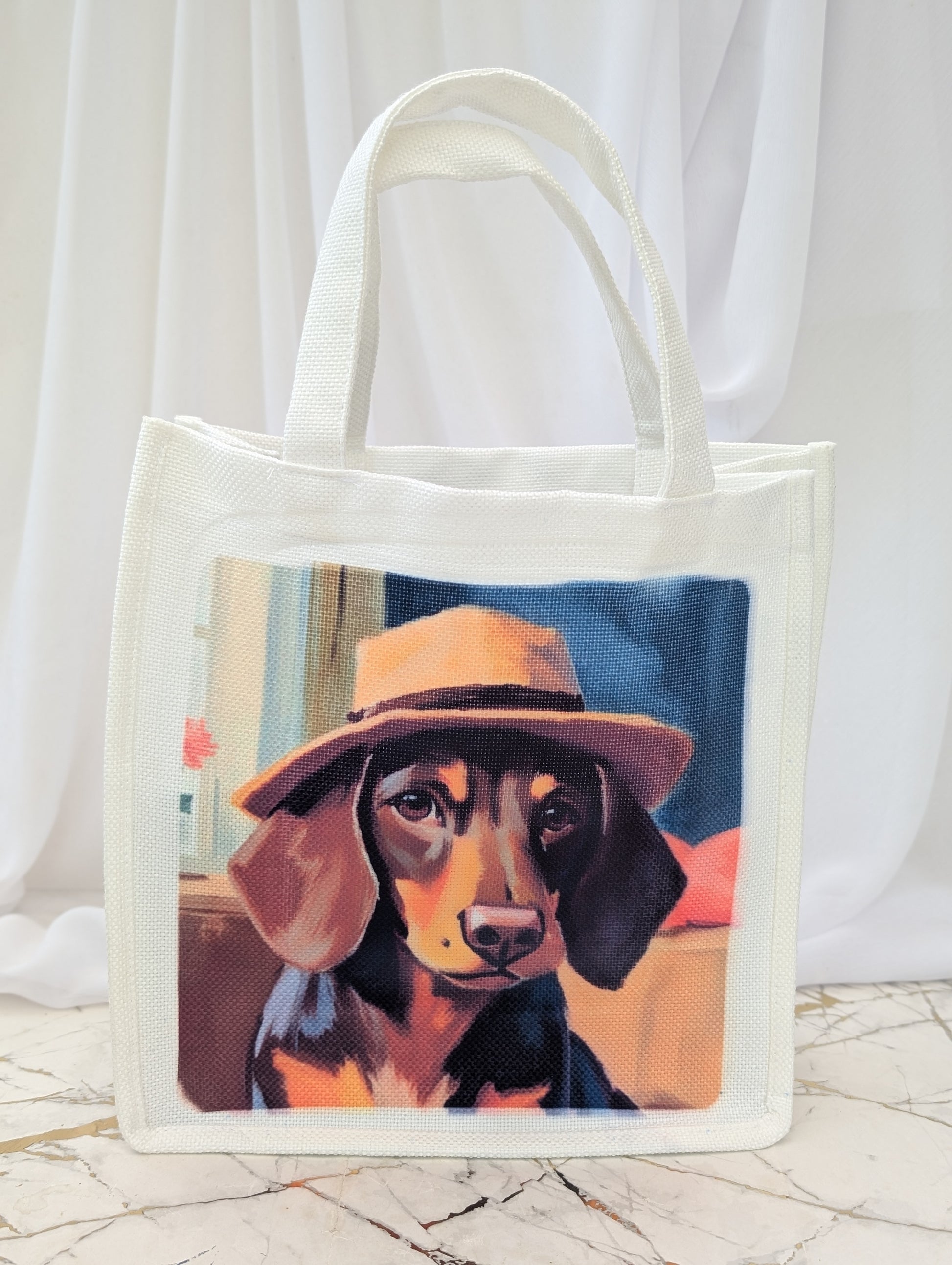 Tote bag with a painting of a dog wearing a hat on a white background