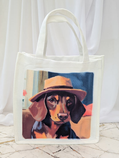 Tote bag with a painting of a dog wearing a hat on a white background