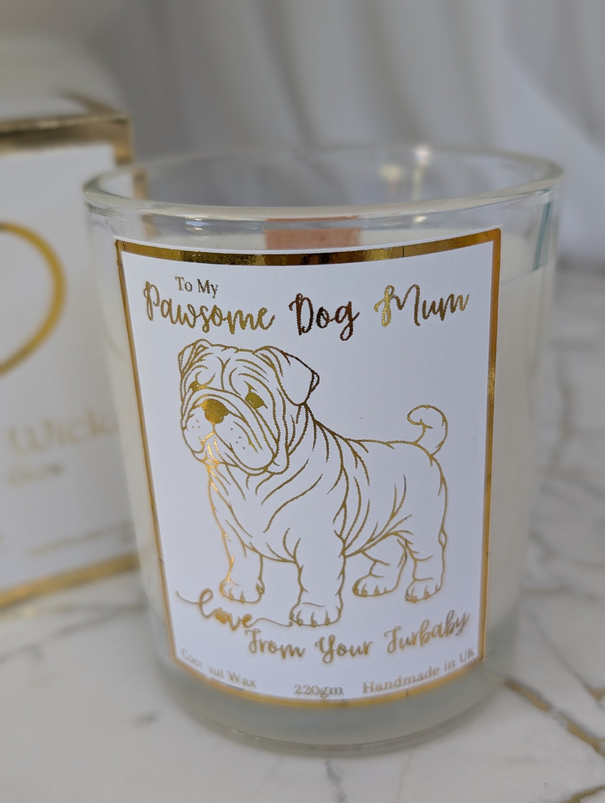 Close up of Pawsome Dog Mum Love from your furbaby candle - Bulldog mum candle in clear glass container with gold foiled label