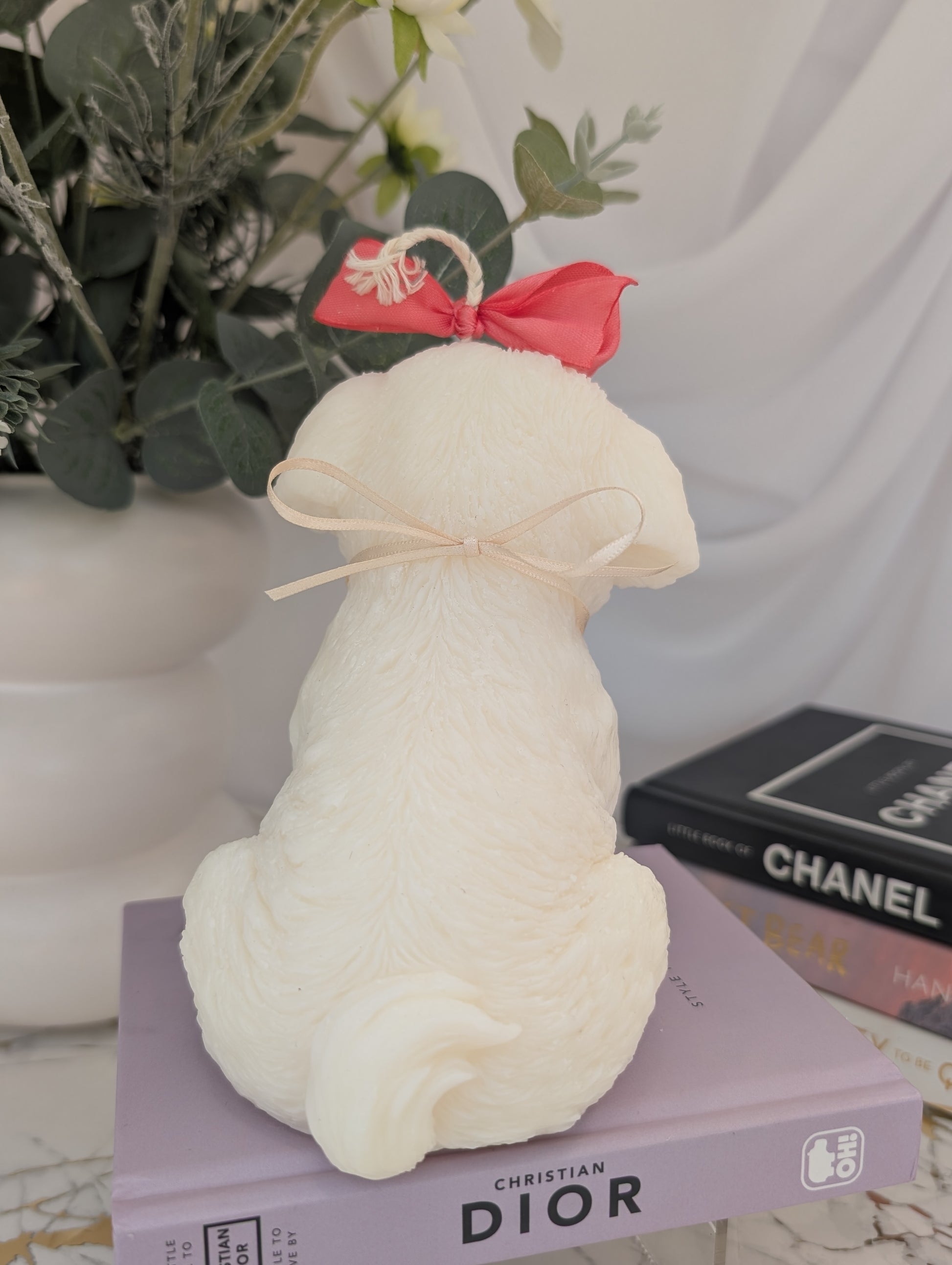 Back view of dog shaped candle - shih tzu natural colour coconut and rapeseed wax with pink ribbon and removable charm