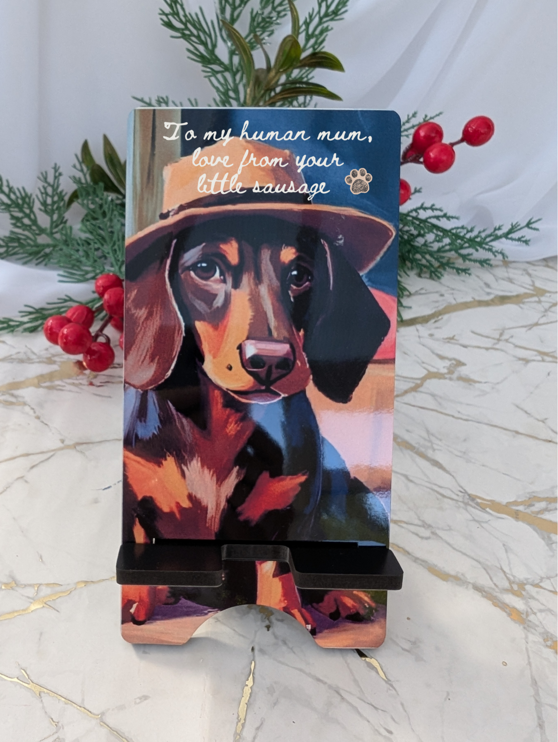 Mobile Phone stand with dachshund design and text on a marble surface with decorative elements.