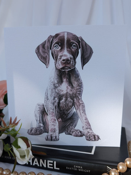 Front view of white linen effect greeting card, printed with a watercolour style image of a German Short Haired Pointer Puppy. 