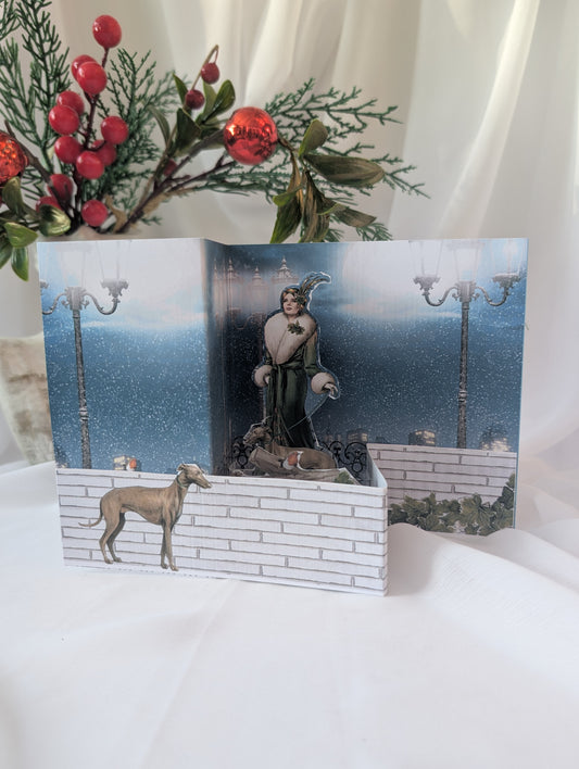 Pop up Christmas Card with a winter scene featuring a woman and greyhound in art deco style, surrounded by festive decorations.