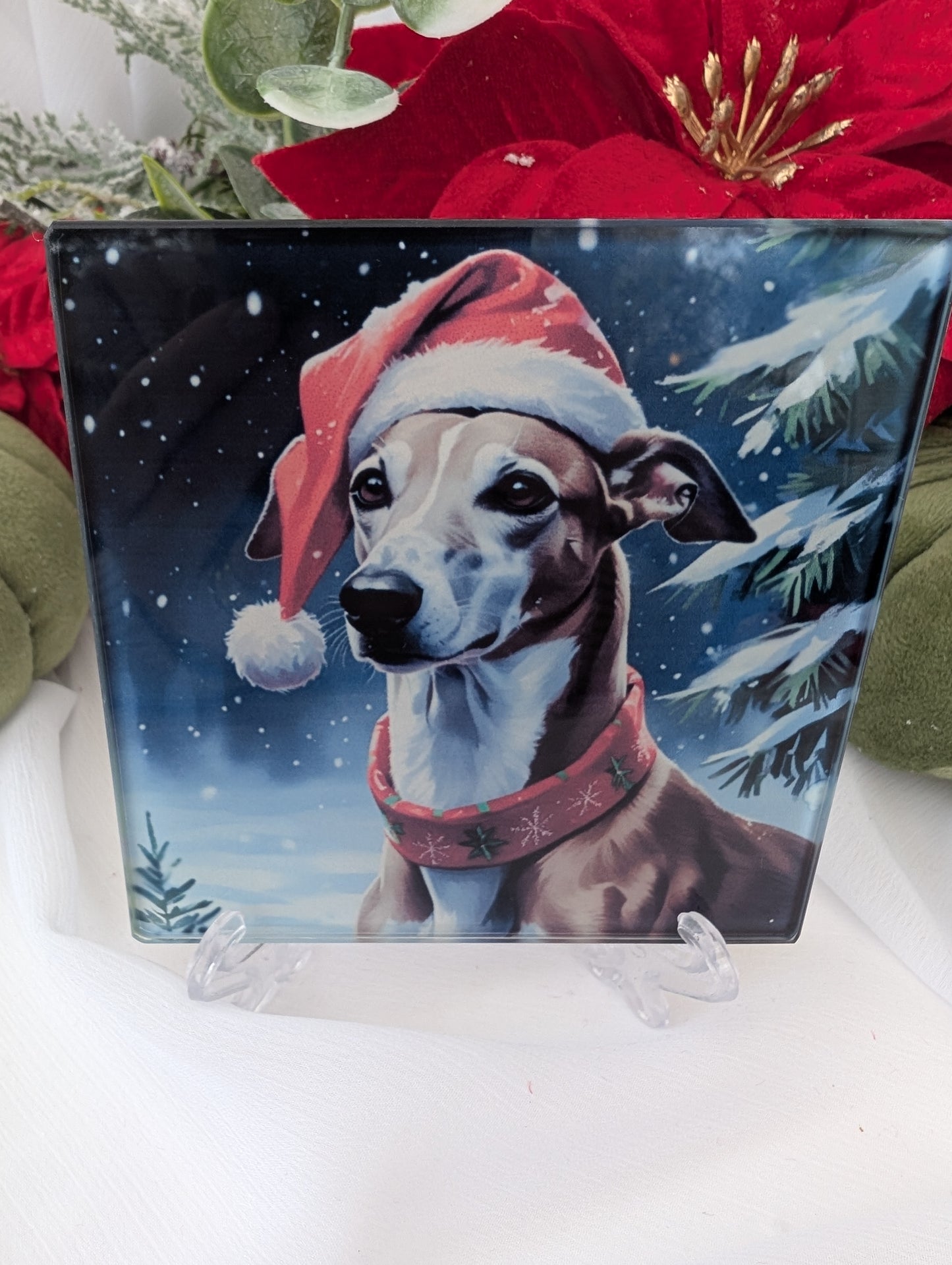 Greyhound Gifts - Glass coaster featuring a handsome greyhound wearing a Santa hat and Christmas sweater against a snowy background.