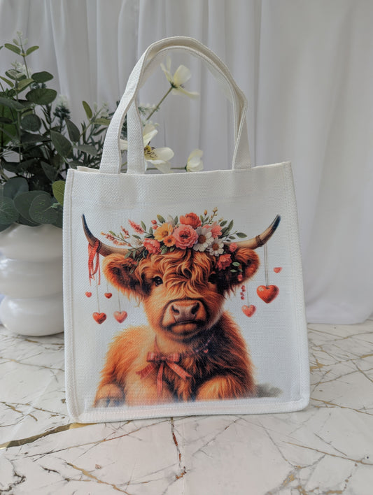 Highland Cow Gift - Tote bag with cow wearing a floral crown on a marble surface.