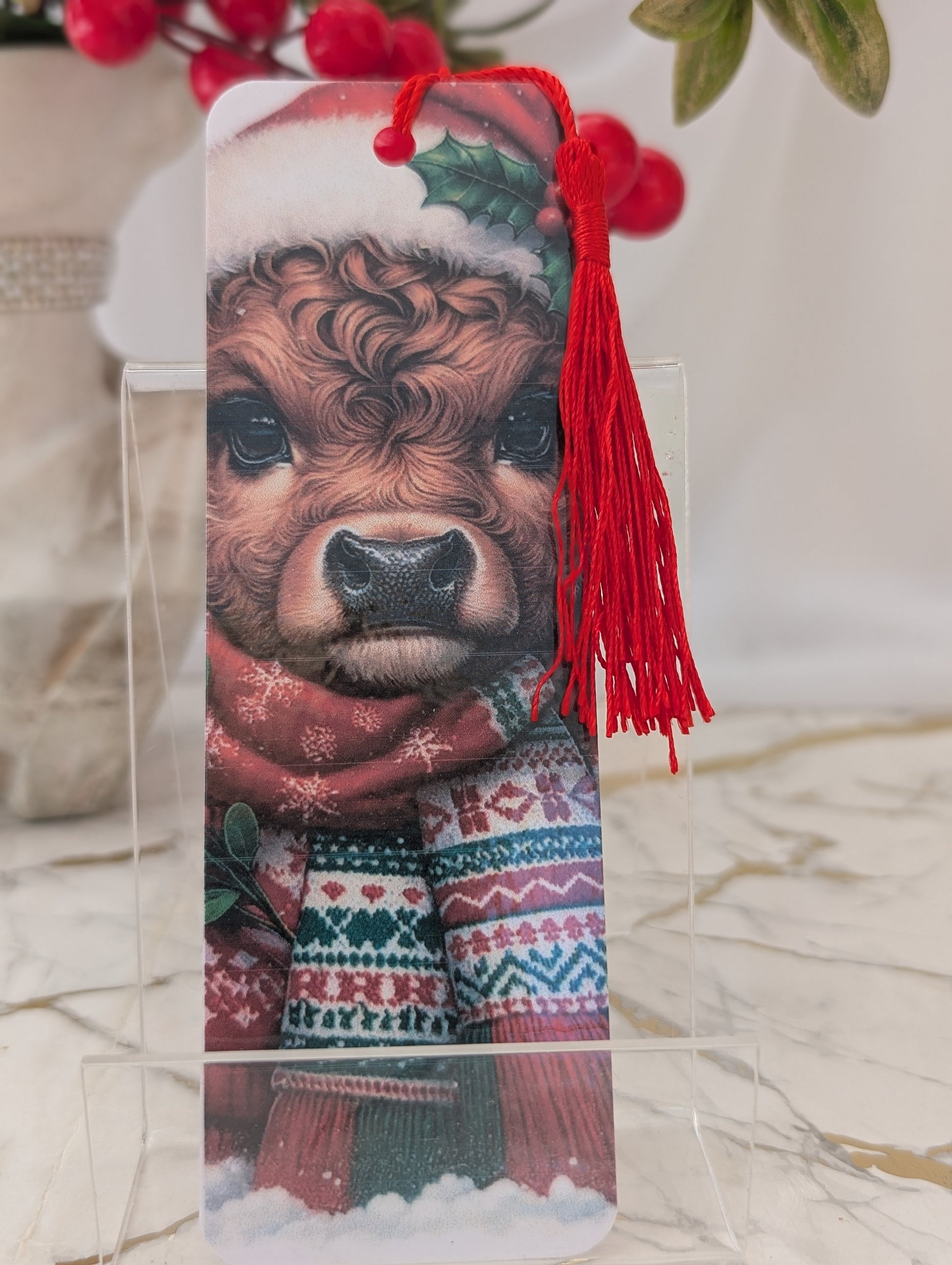 Christmas gift idea - highland cow bookmark. Christmas themed, wearing a santa hat and Christmas scarf