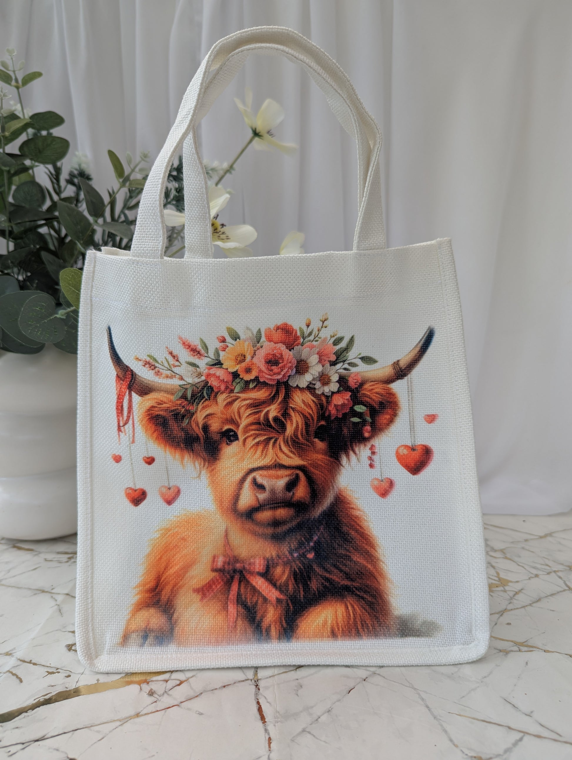 Highland Cow Gift - Tote bag with cow wearing a floral crown and hearts dangling from her horns