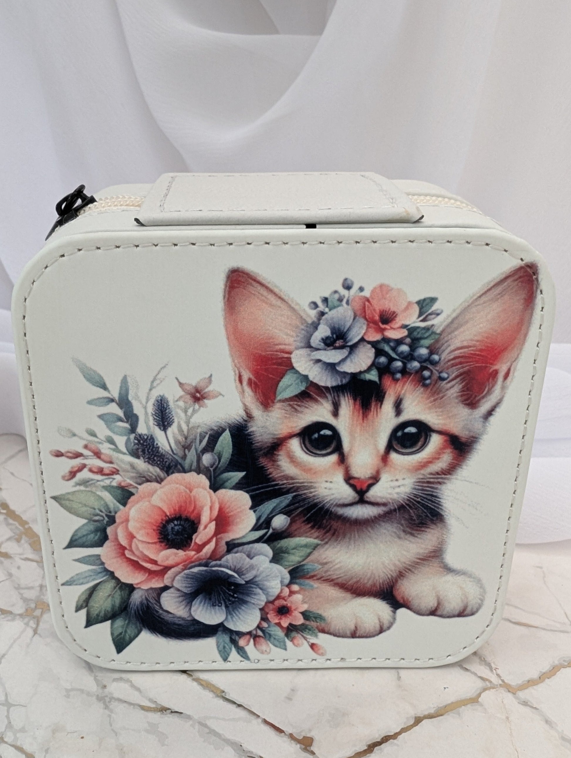 Cat Gift - travel jewellery box with a design of a kitten and flowers on a marble surface.