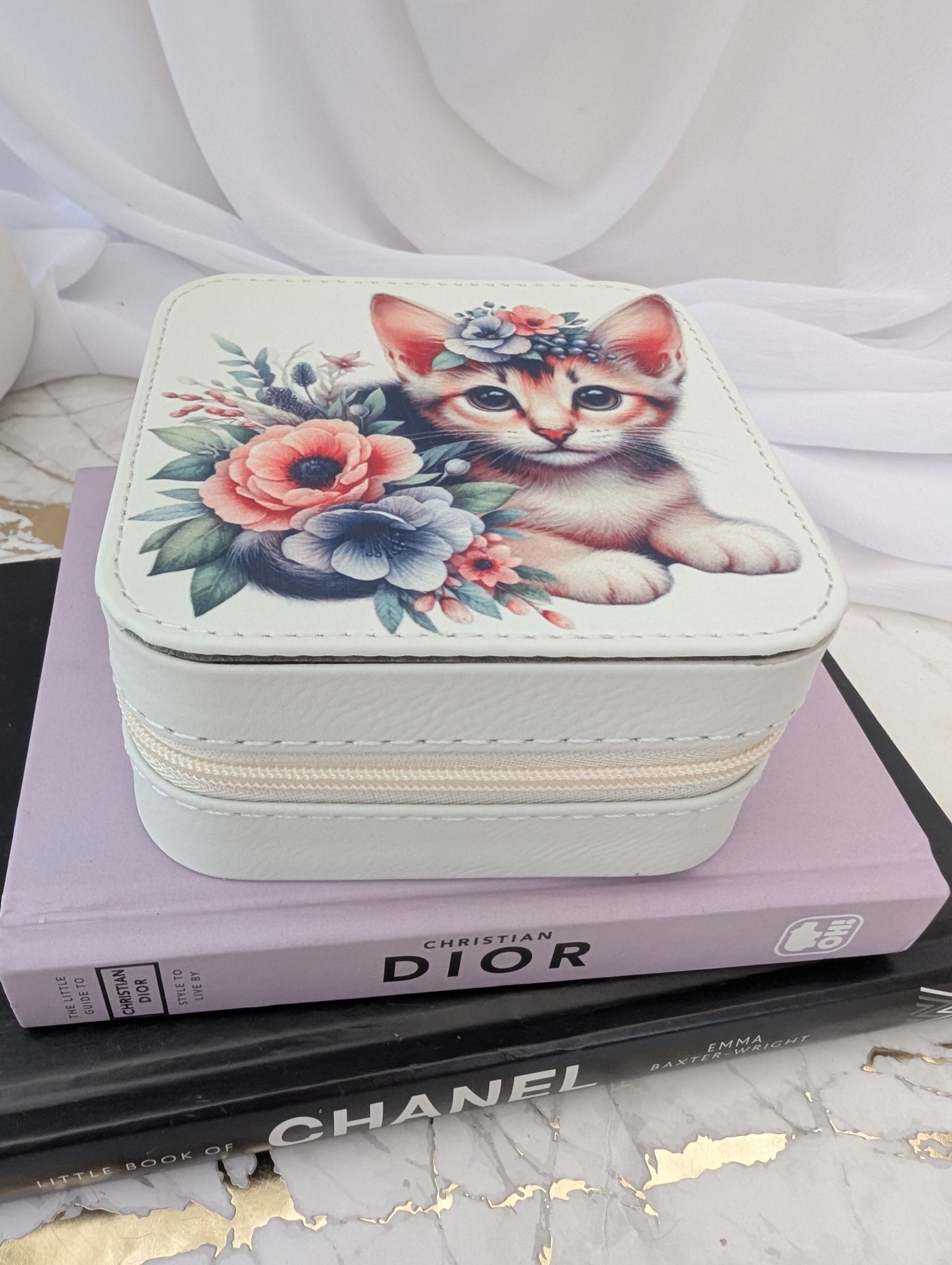 Cat Gift - cream faux leather travel jewellery box with a design of a kitten and flowers on a marble surface.