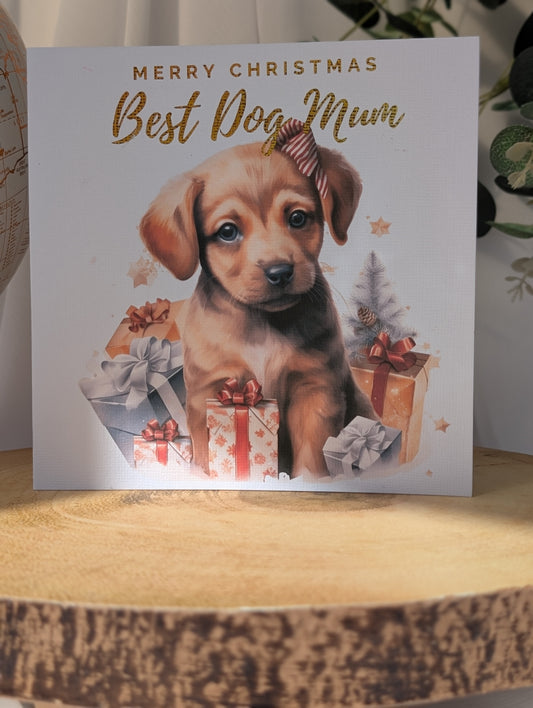 Dog Christmas card with a Labrador puppy and gift boxes on a wooden surface