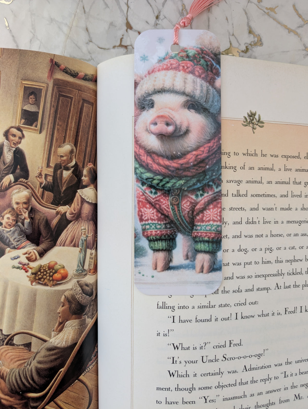Cute Christmas Pig bookmark shown on an open illustrated copy of a Christmas Carol