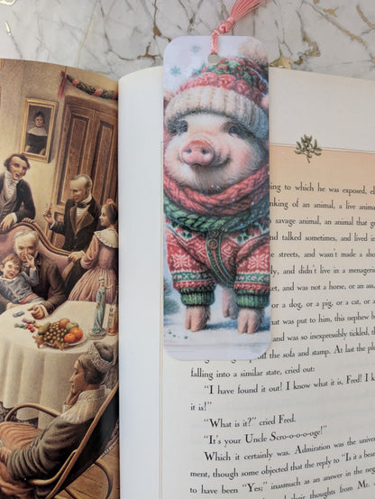Cute Christmas Pig bookmark shown on an open illustrated copy of a Christmas Carol