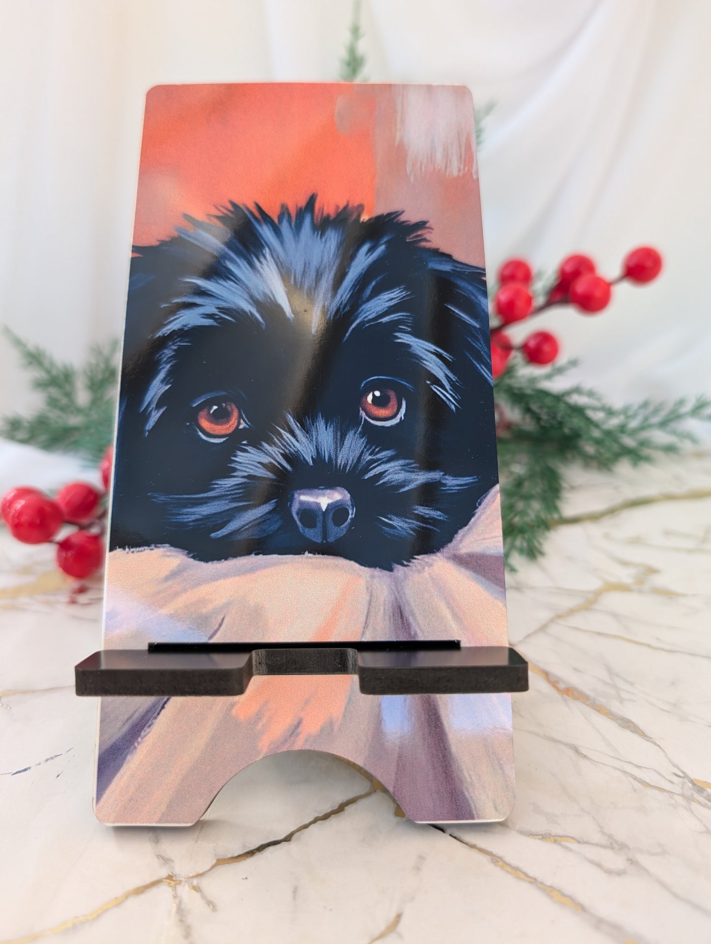 Cockapoo gifts - Phone stand with a black cockapoo illustration on a decorative surface with berries and greenery.