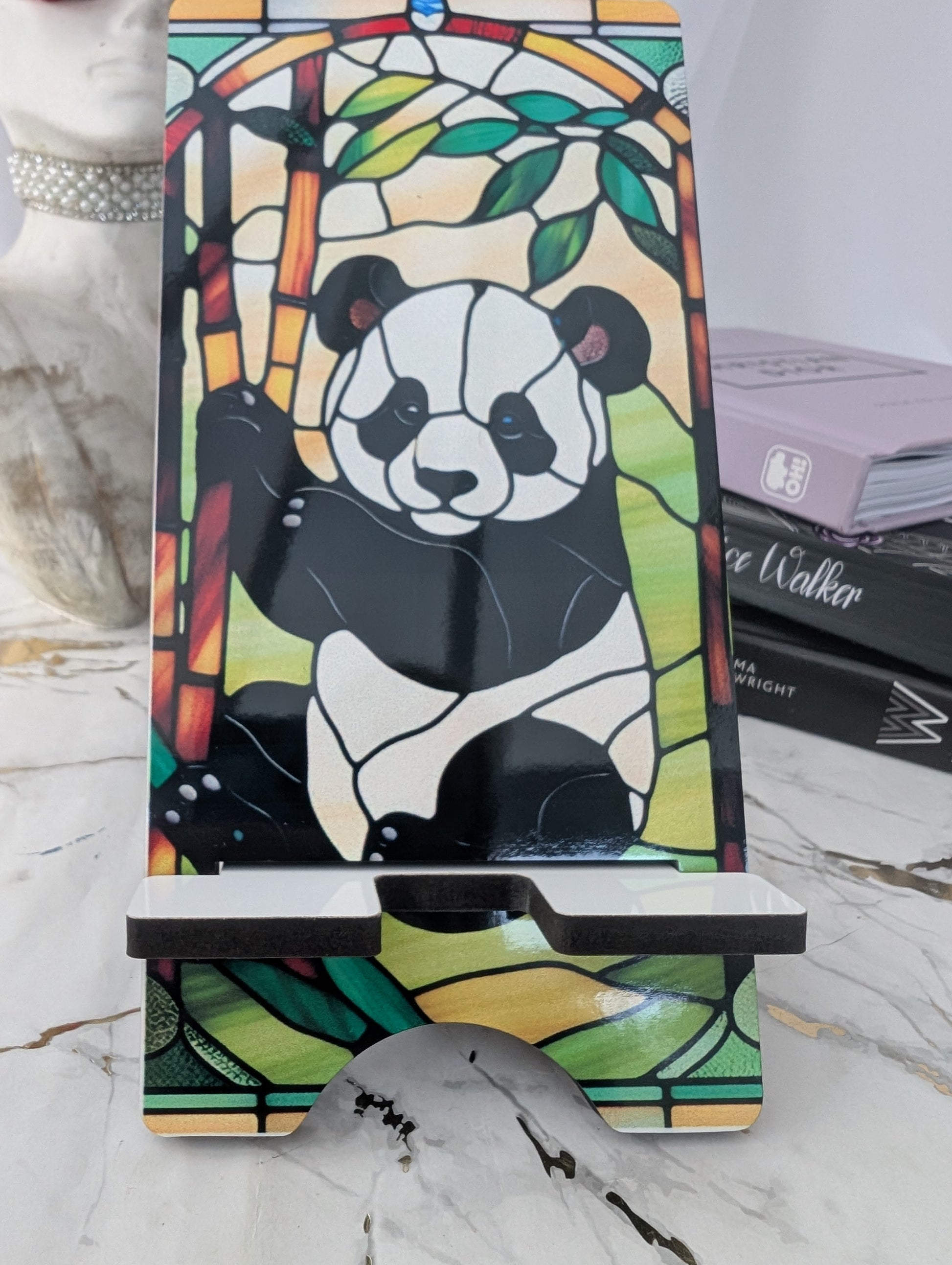 Phone stand with panda design in stained glass style on a marble surface