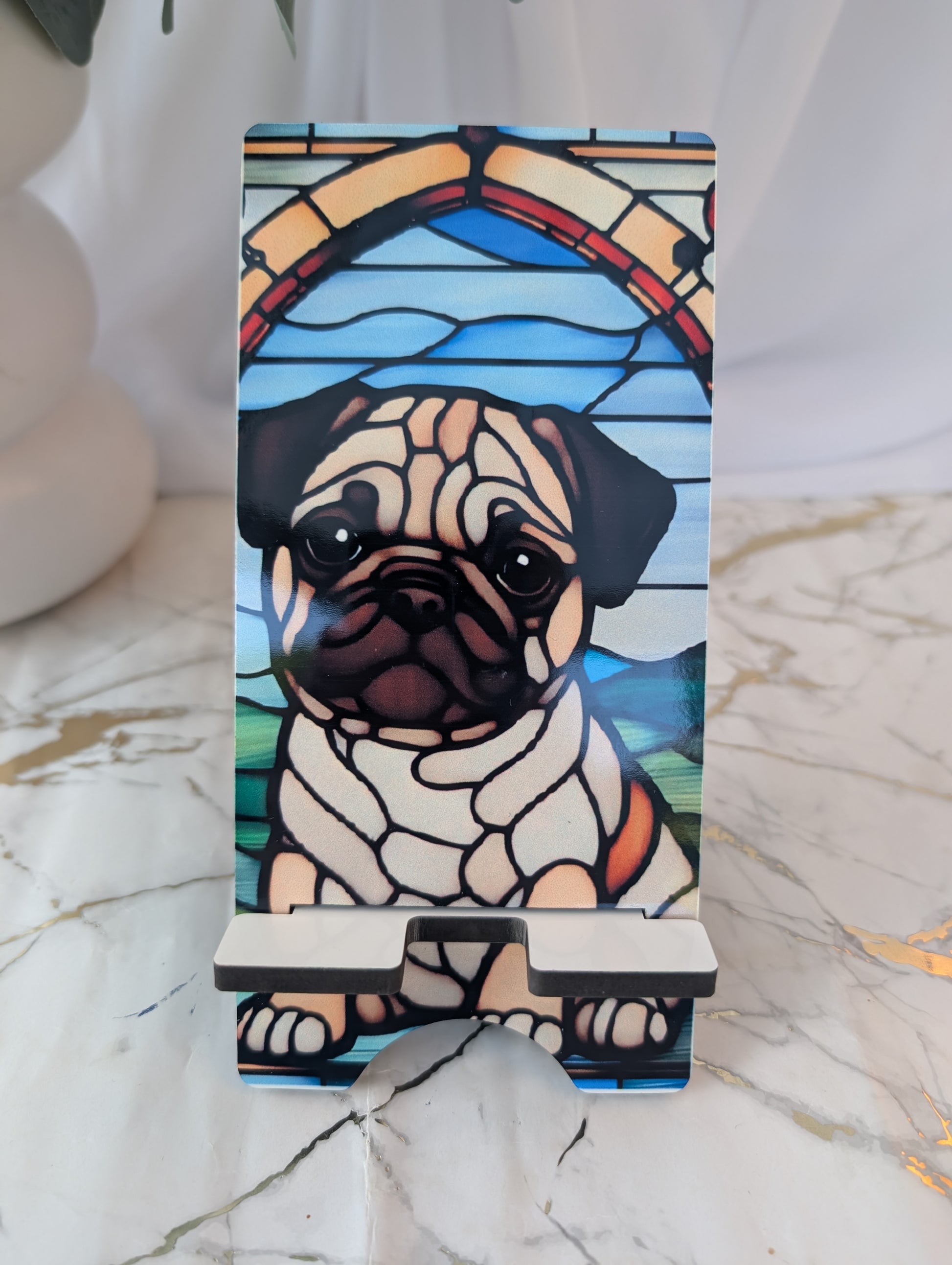 Phone stand with pug design in stained glass style on a marble surface