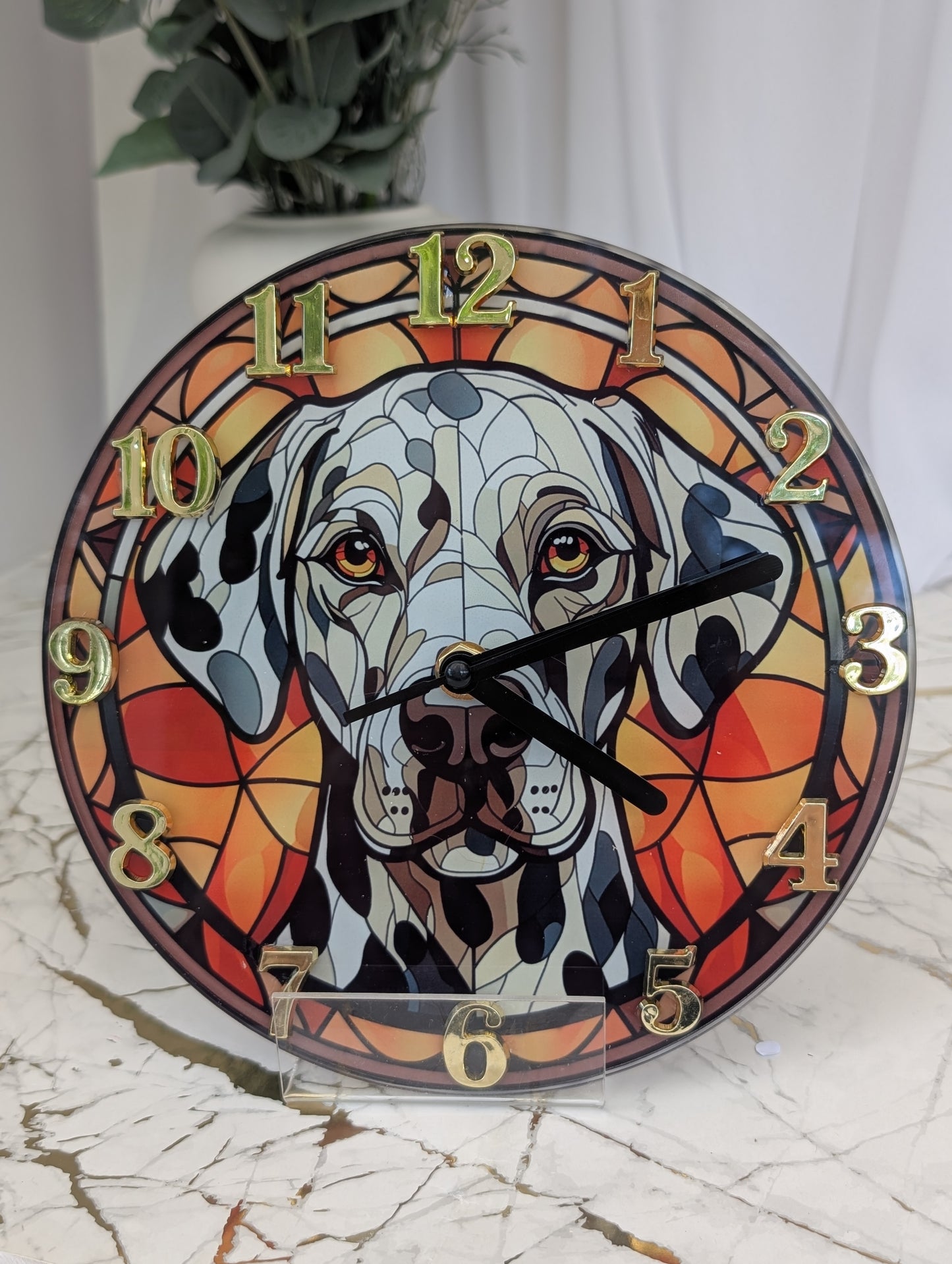 20cm round Dalmation wall clock, stained glass style in red tones, with gold coloured numerals and black hands.  