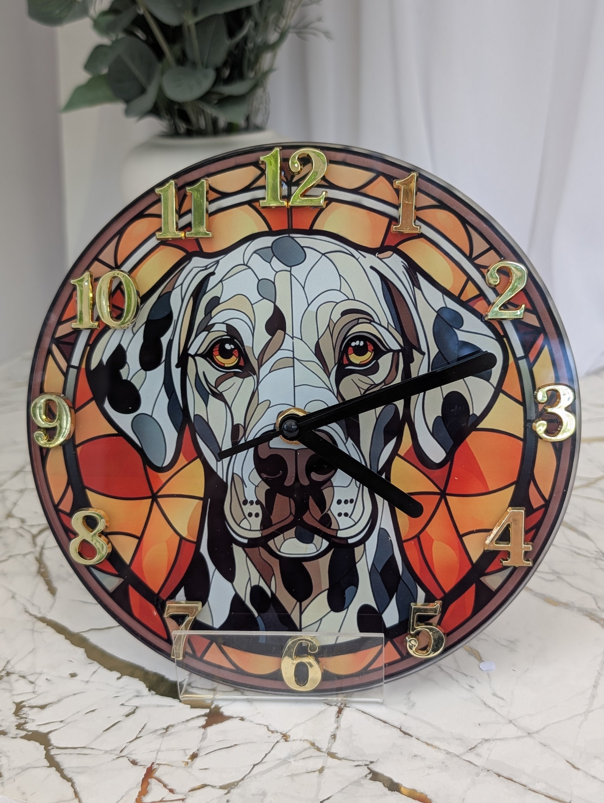 20cm round Dalmation wall clock, stained glass style in red tones, with gold coloured numerals and black hands.  