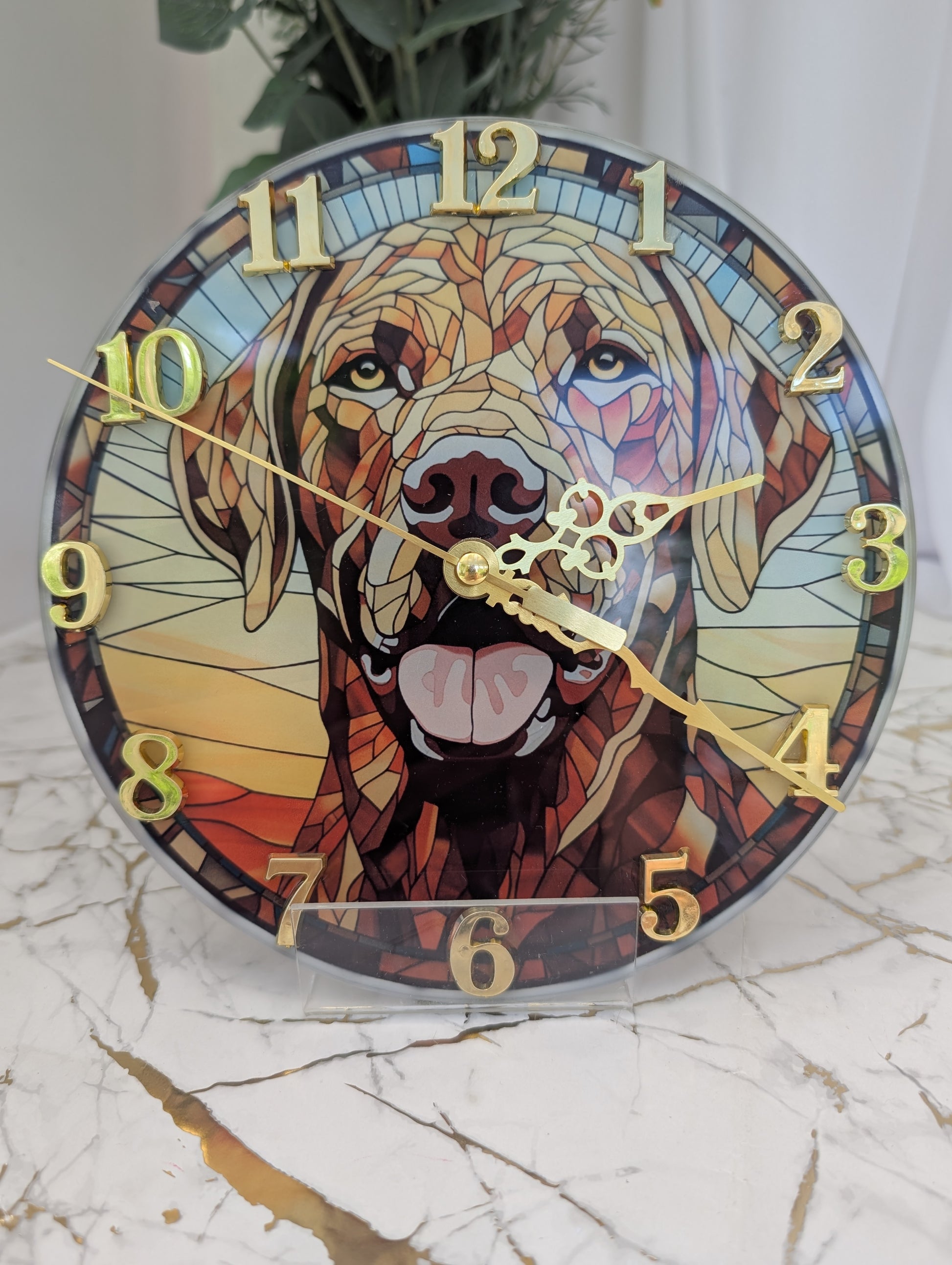close up of 20cm diameter, round,  stained glass style, Labrador wall clock with gold numbers and clock hands