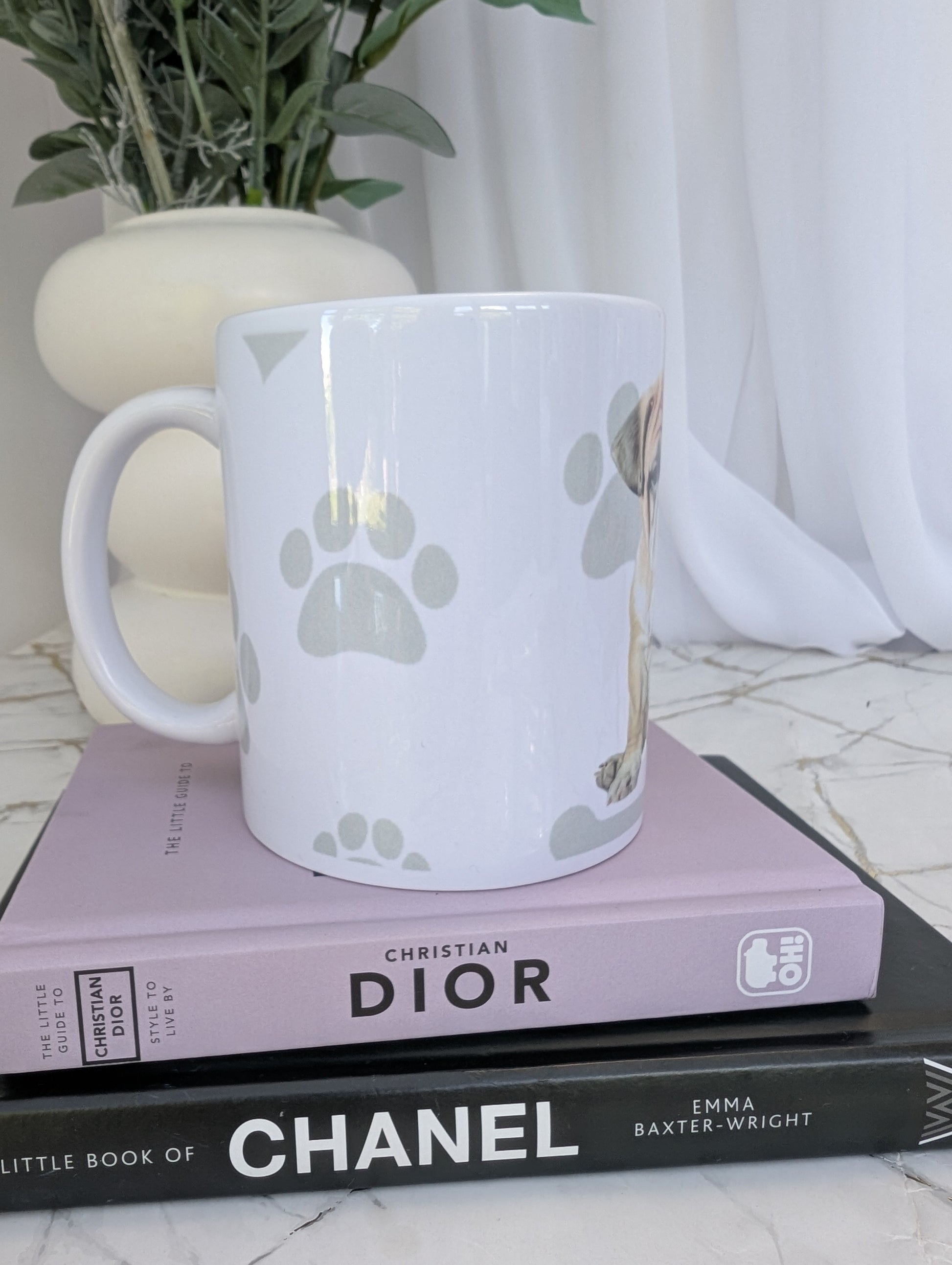 side view of white ceramic Bulldog mug, watercolour style image on a background of pale grey paws, hearts and bones
