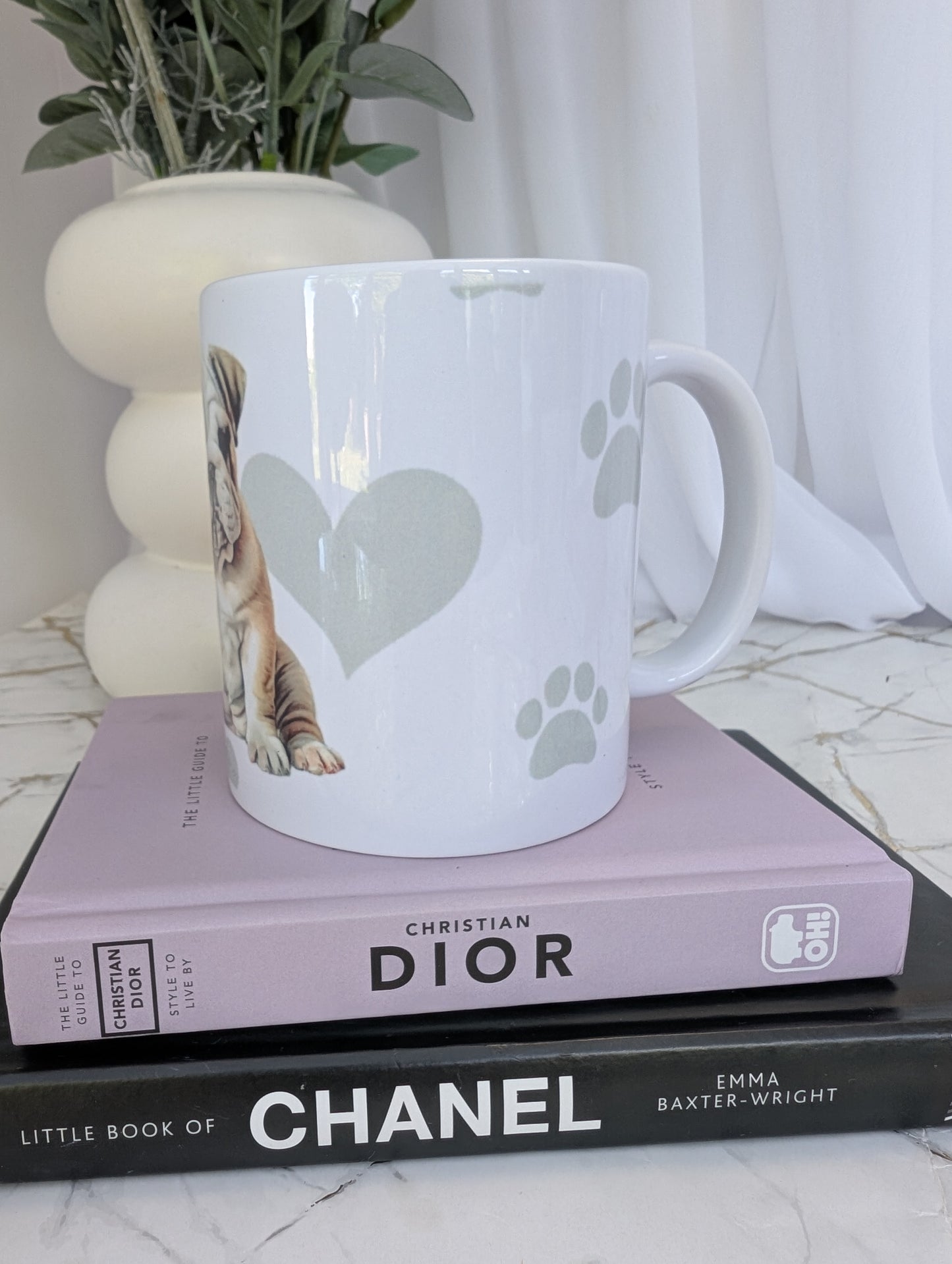 left side view of white ceramic Bulldog mug, watercolour style image on a background of pale grey paws, hearts and bones