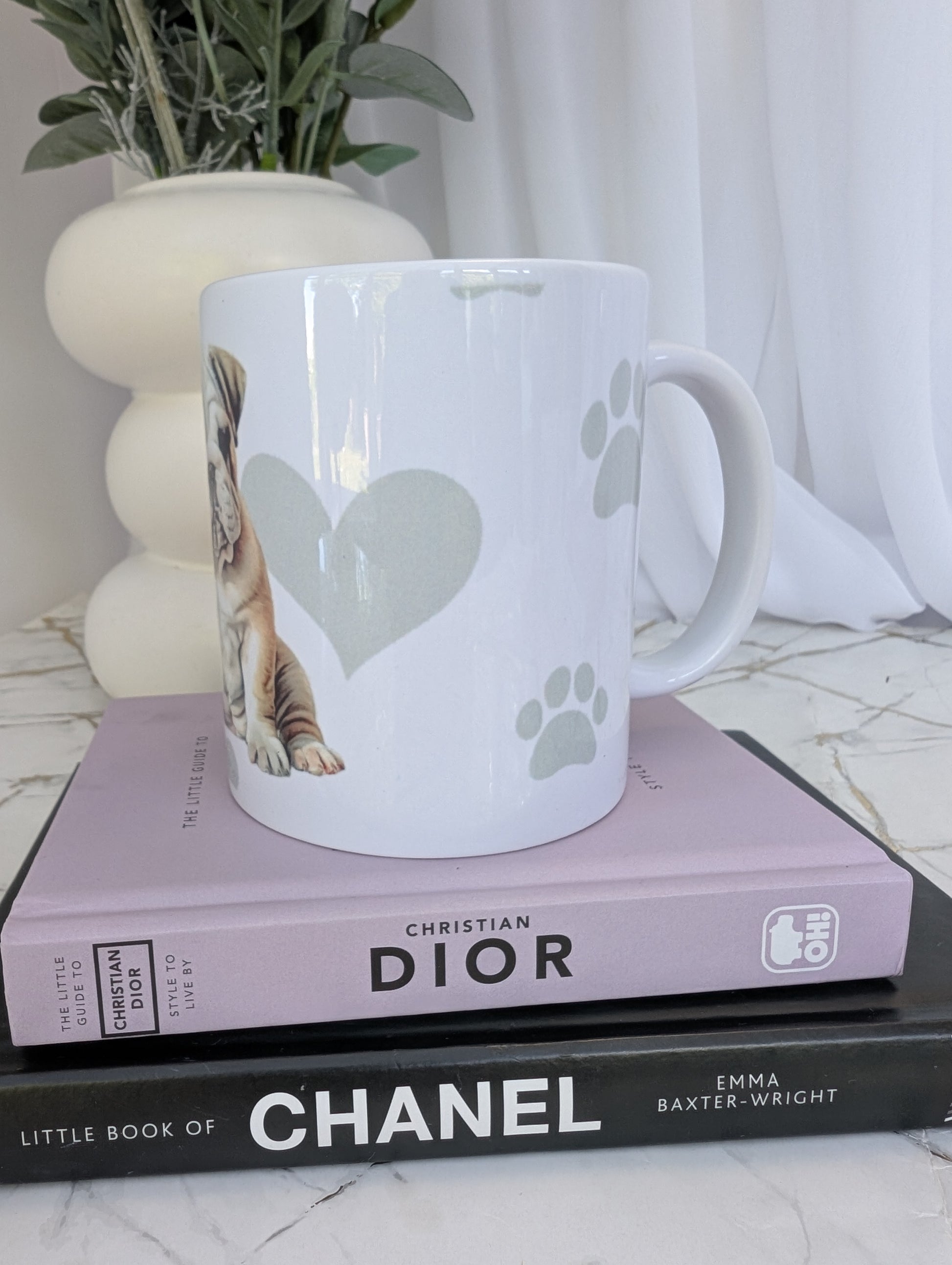 left side view of white ceramic Bulldog mug, watercolour style image on a background of pale grey paws, hearts and bones
