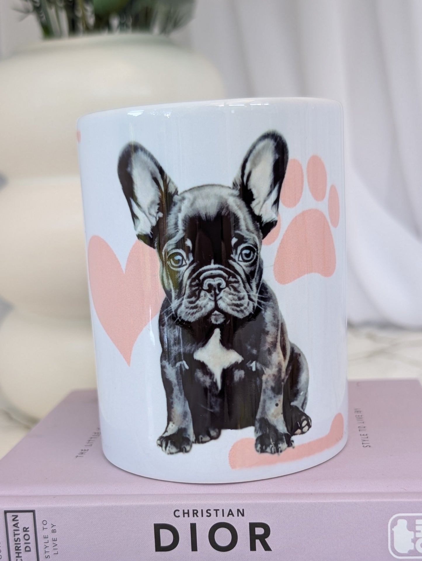 Black colour French Bulldog on a white ceramic mug with background of pink hearts, paws and bones