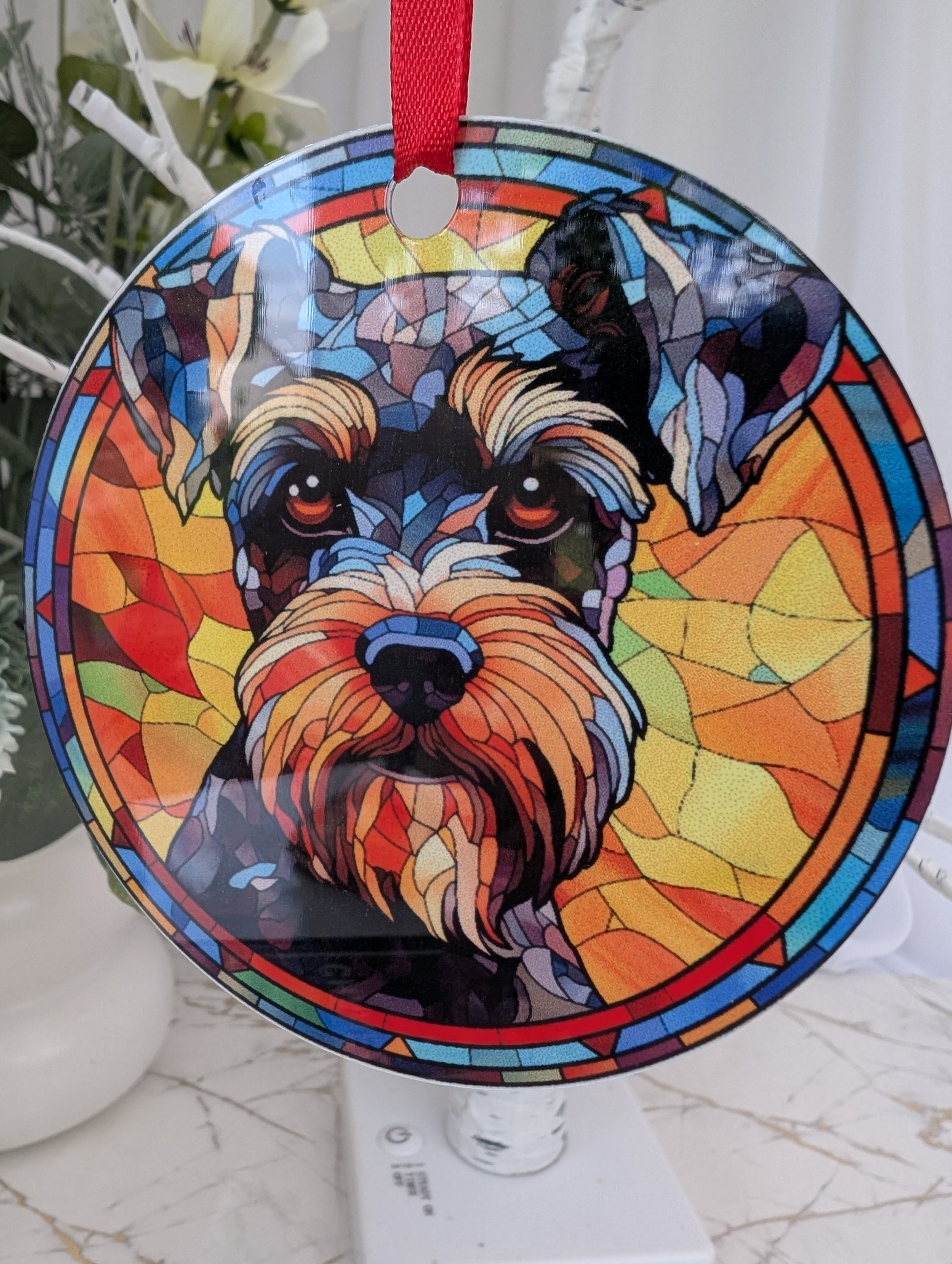 Close up of lightweight aluminium, multicolour, 9cm round Schauzer dog hanging ornament in stained glass style.  Printed on both sides.