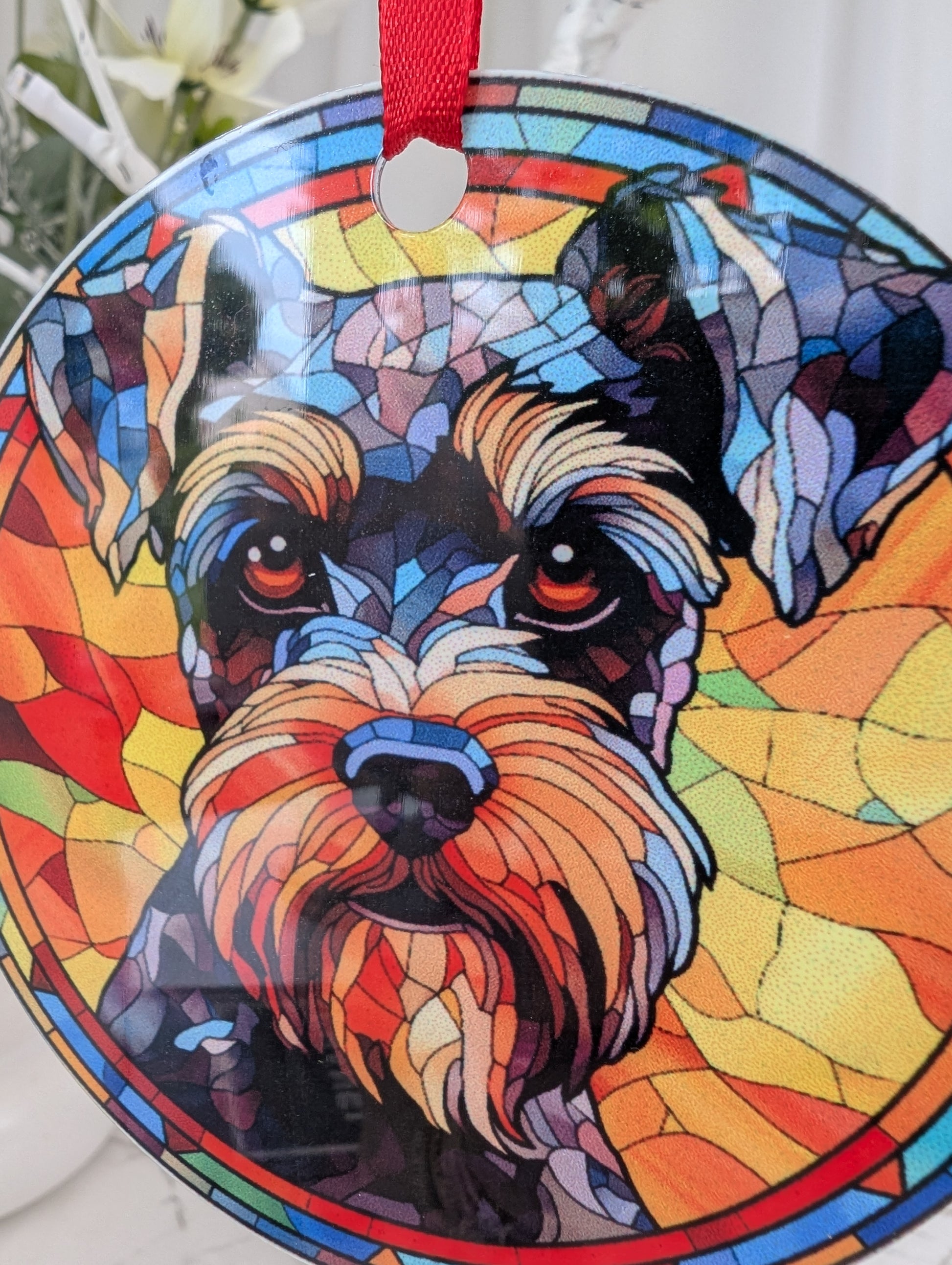detailed close up of aluminium, multicolour, 9cm round Schauzer dog hanging ornament in stained glass style.  Printed on both sides.