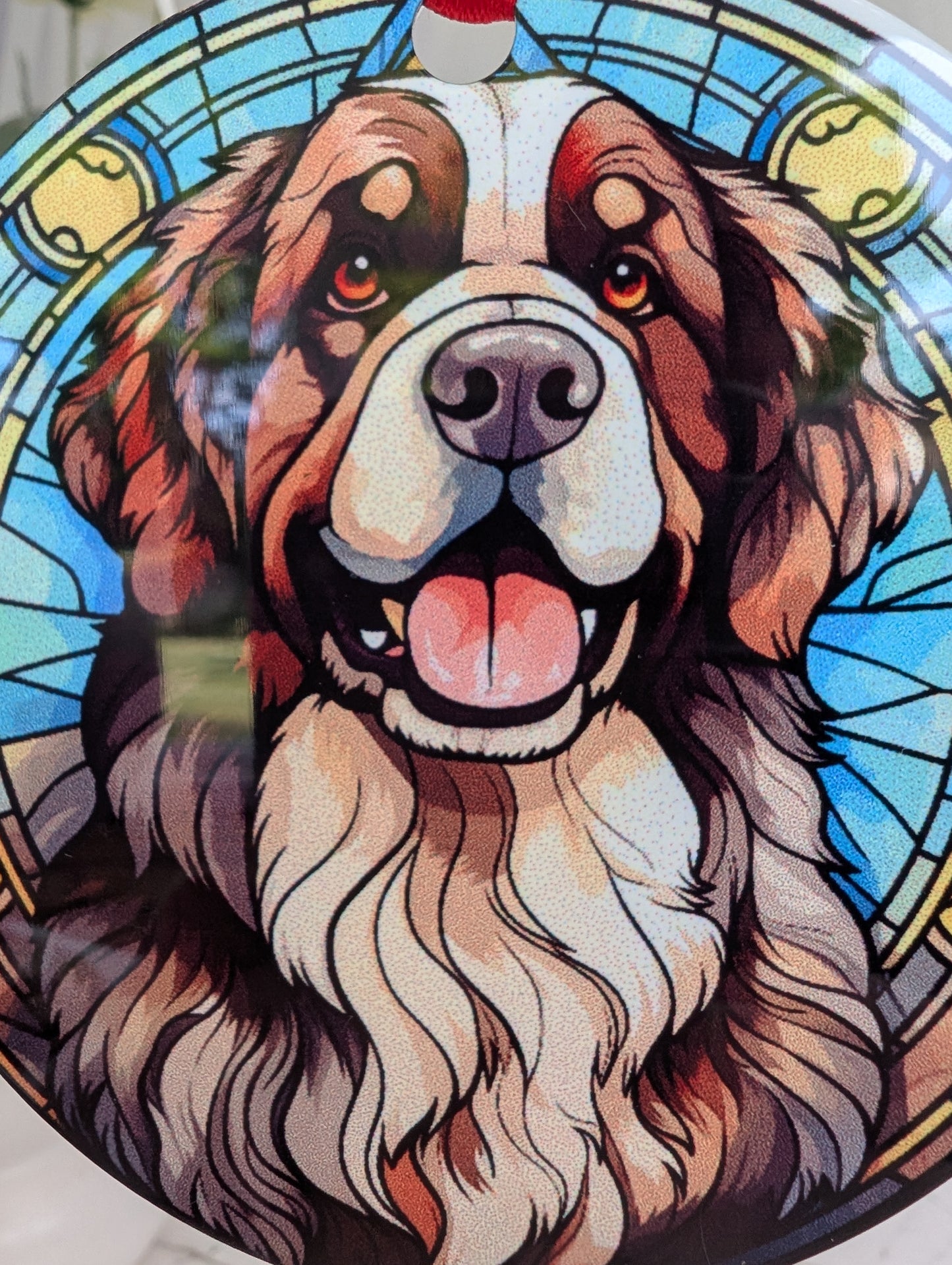 extreme close up of stained glass effect, round, Newfoundland Dog ornament on an aluminium base.  