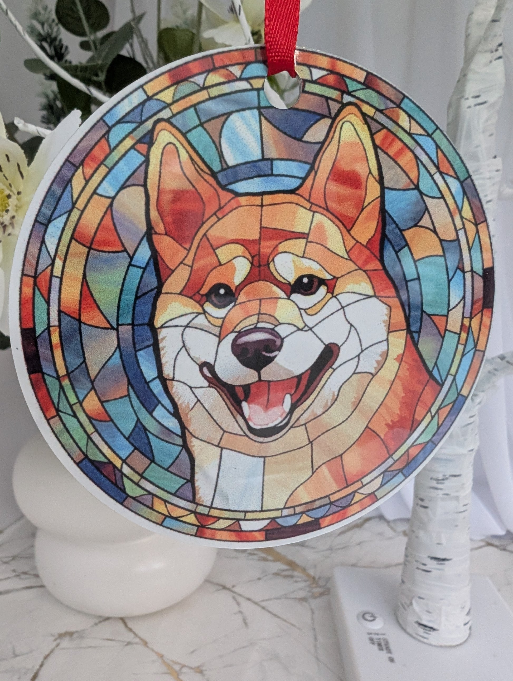 Close up of round, multi colour, stained glass style Shiba Inu hanging ornament