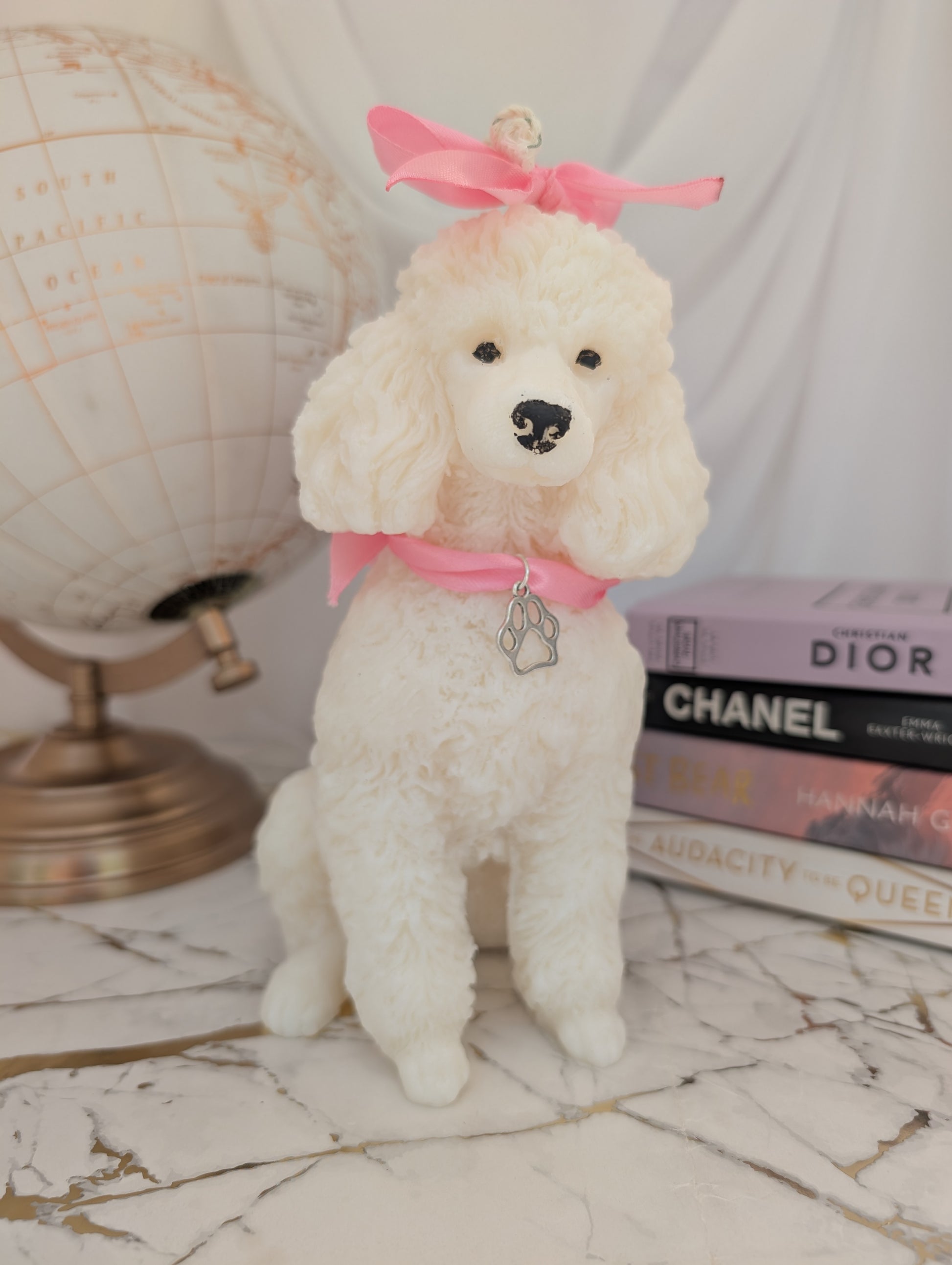 Front view of 14cm poodle candle made from coconut and rapeseed wax, with decorative charm collar and head accessory