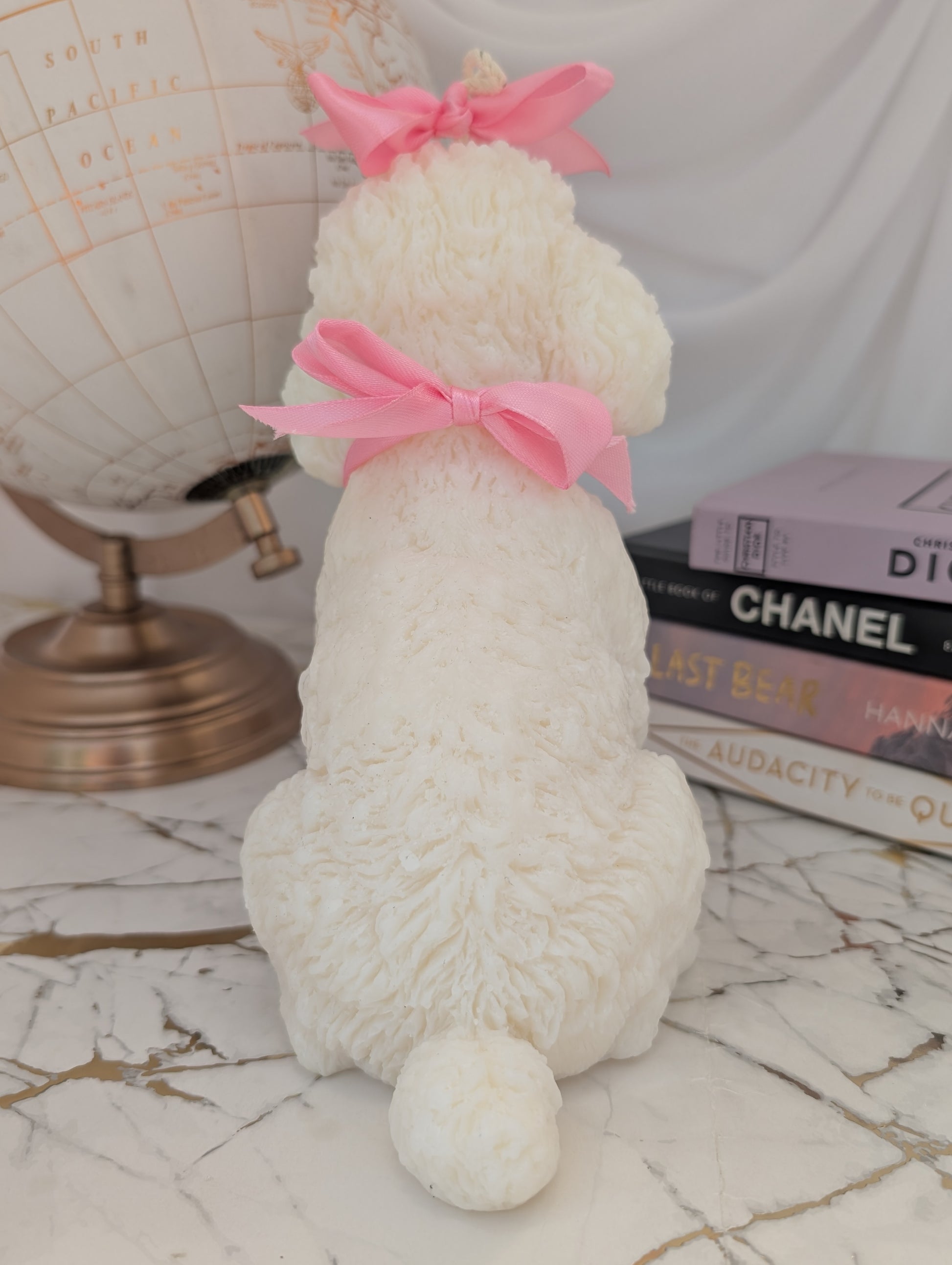 Rear view of detailed poodle candle, capturing textured wax fur, sculpted tail, and clean finish in natural tones