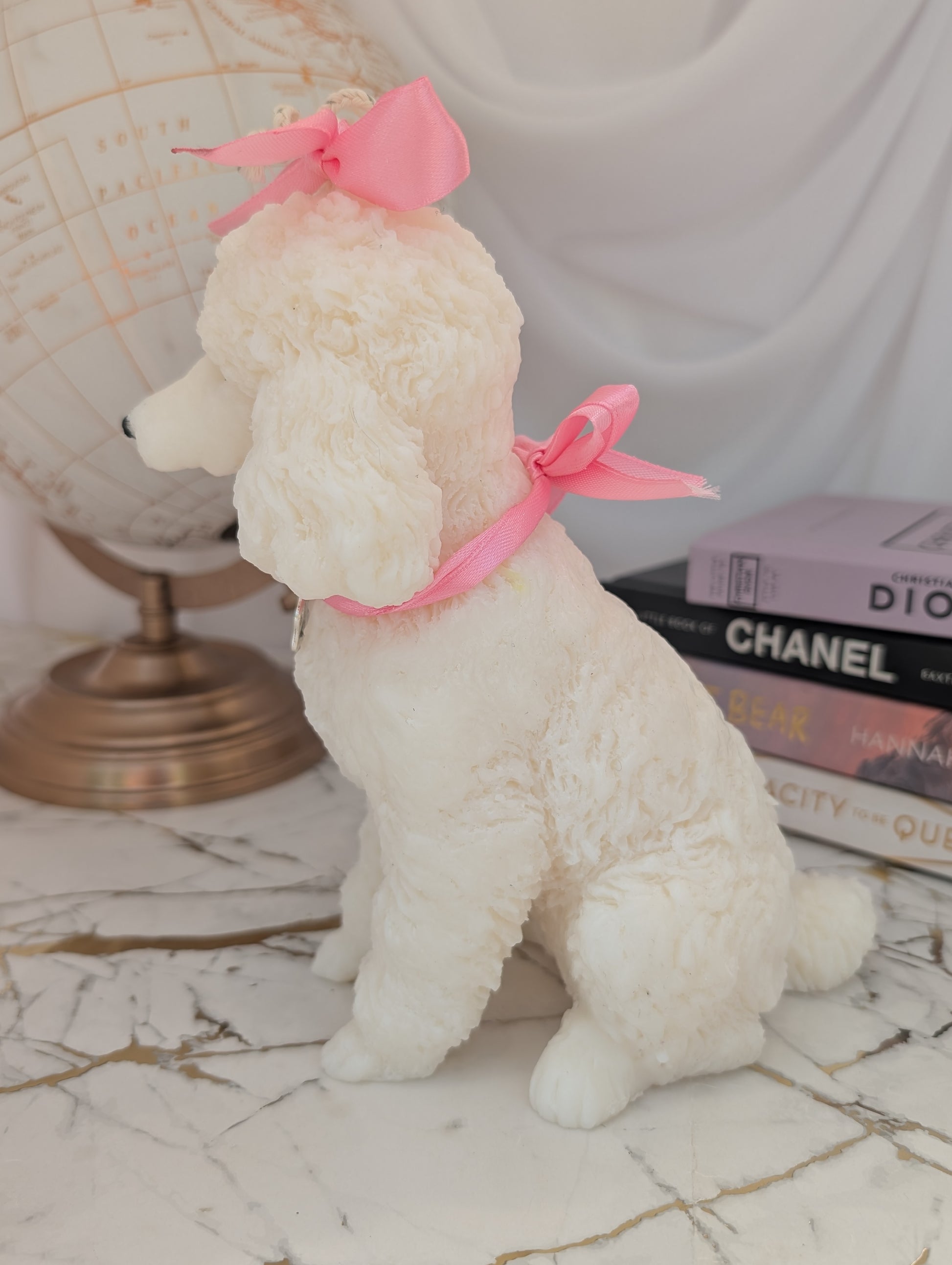Left-side profile of realistic poodle candle, highlighting textured fur and wax craftsmanship with visible charm details