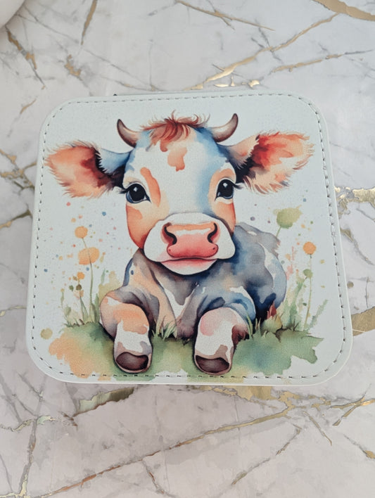 close up of cute cow design cream faux leather mini jewellery box measuring 9.5 x 9.5 cm