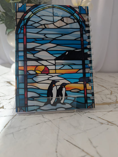 Back cover of penguin notebook with stained glass design featuring penguins in the antarctic