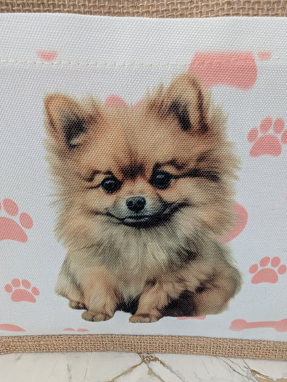 close up of eco friendly jute tote bag with cream front pocket printed with Pomeranian dog and background of pink pawprint, hearts and bones