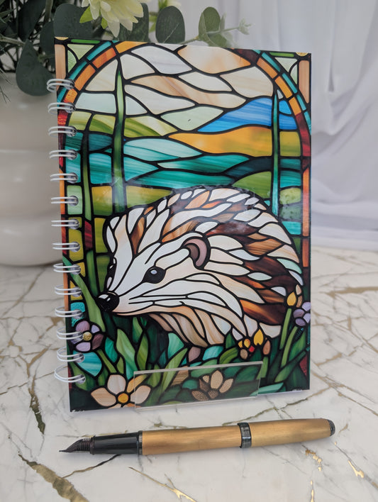 Front cover of colourful stained glass style hedgehog notebook - handmade, spiral bound and hardback - gift for hedgehog lovers