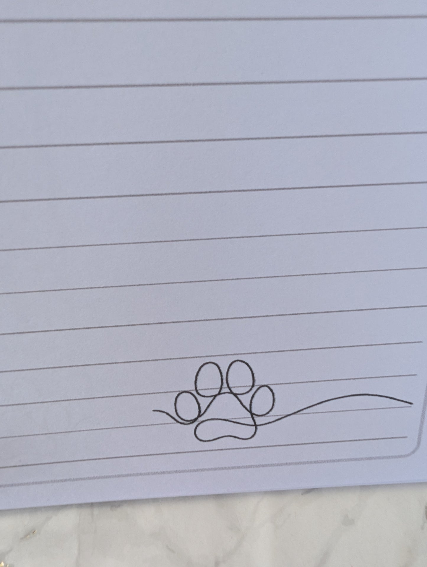 detail of paw print on inside pages of Rottweiler notebook