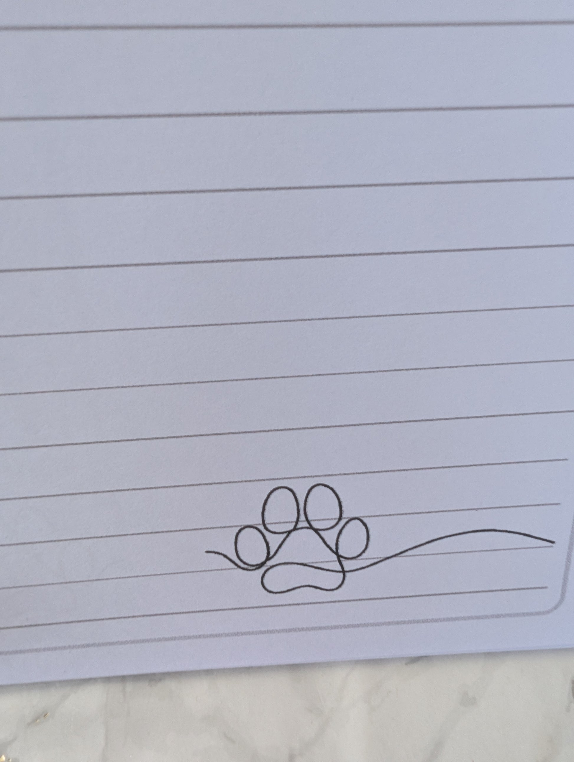 detail of paw print on inside pages of Rottweiler notebook