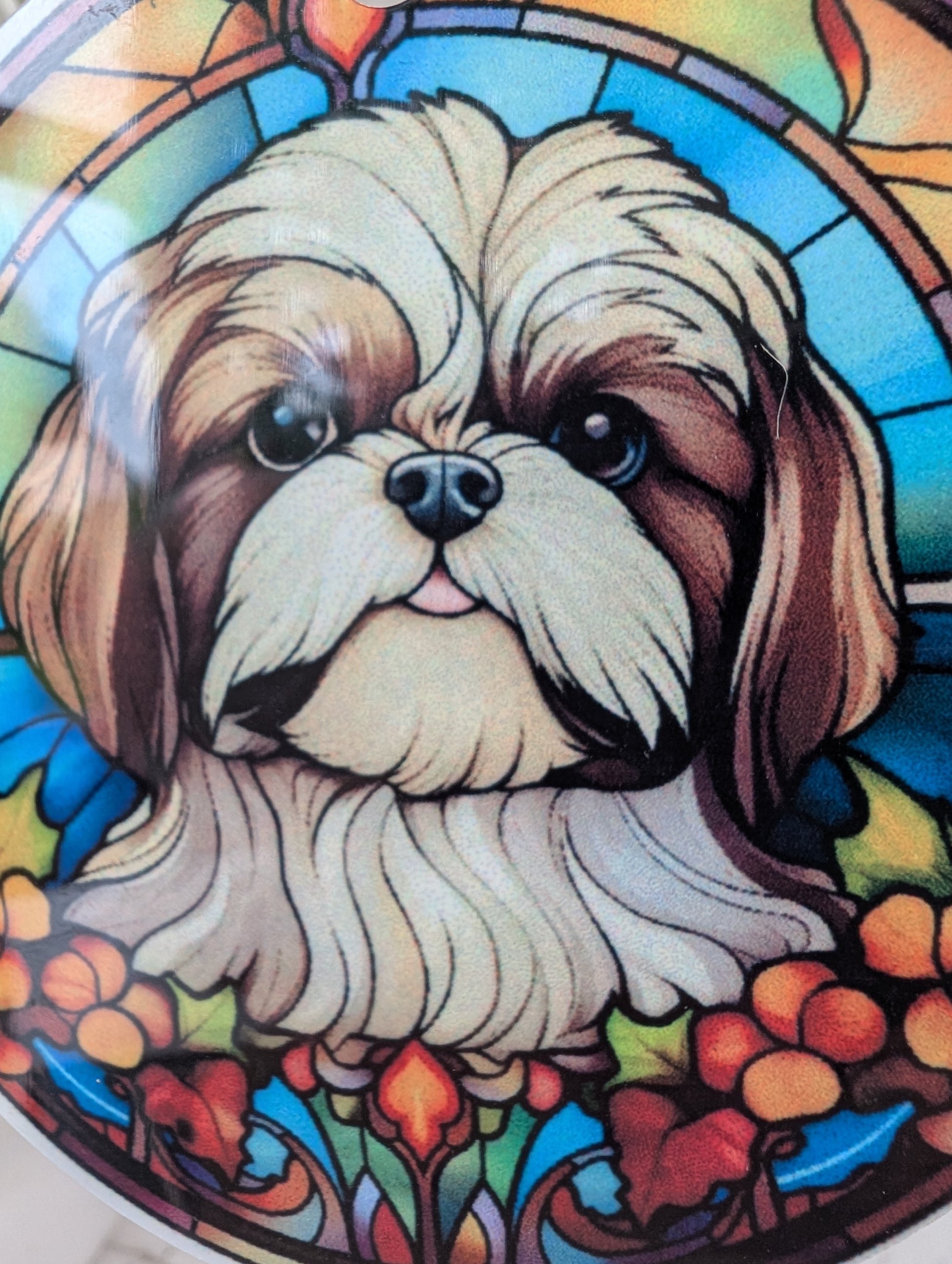 close up of schih-tzu face detail on stained glass effect hanging decoration