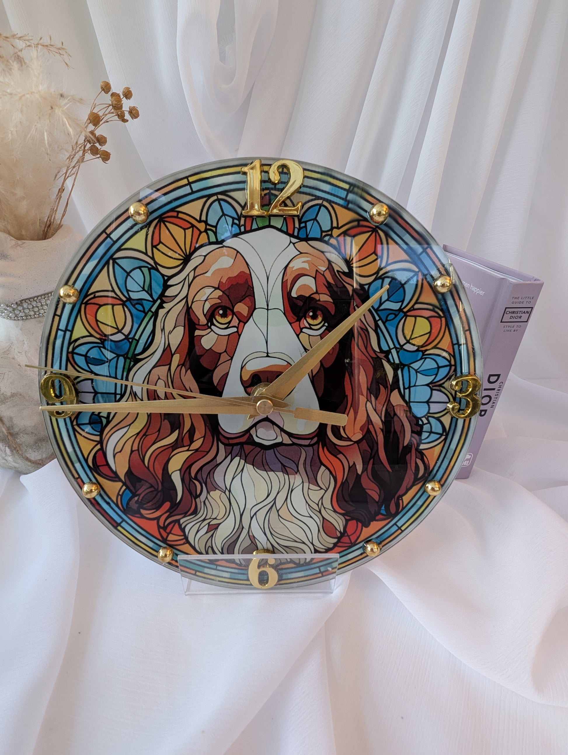 Decorative clock with a colorful springer spaniel illustration on a white background