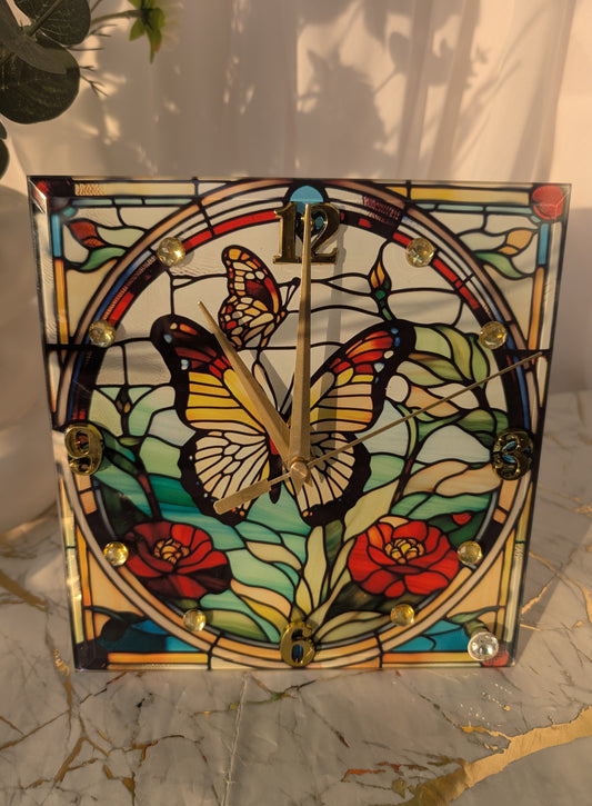 Close-up of stained glass-style butterfly clock with vibrant blue and purple wings on a freestanding base.