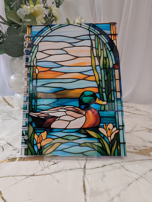 Duck Gift - Front cover of an A5 duck stained glass style, glossy hardback, spiral bound notebook 