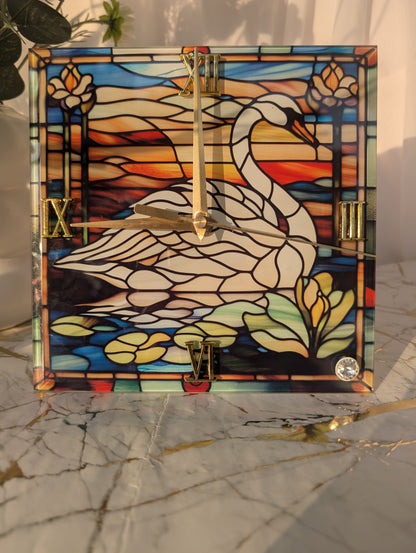 Close-up of 20cm x 20cm swan clock with art glass-style detailing and sleek freestanding base.