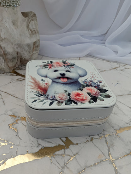 Small square jewelry box with a Bichon Frise and floral design on a marble surface.