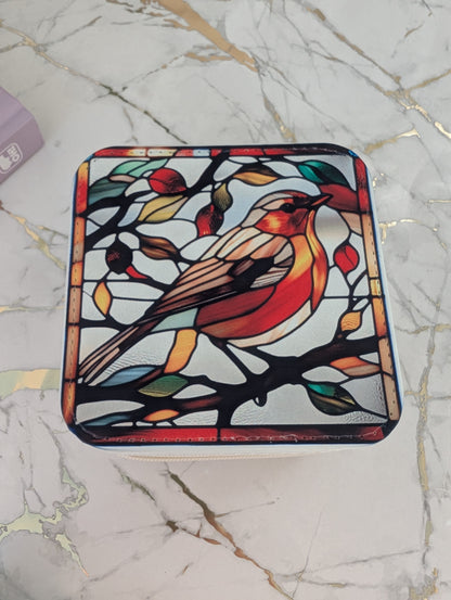 Top view of travel jewellery box in cream faux leather with stained glass robin design